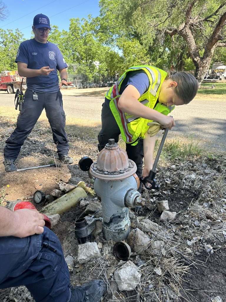 Saint David Fire District members practicing fire hydrant operation during training.